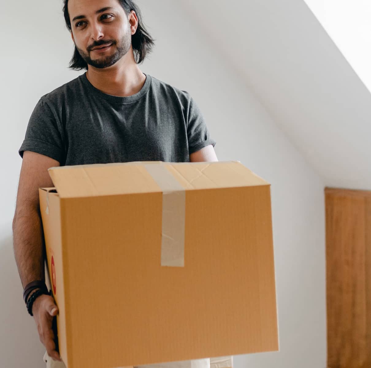 A man carrying a cardboard box