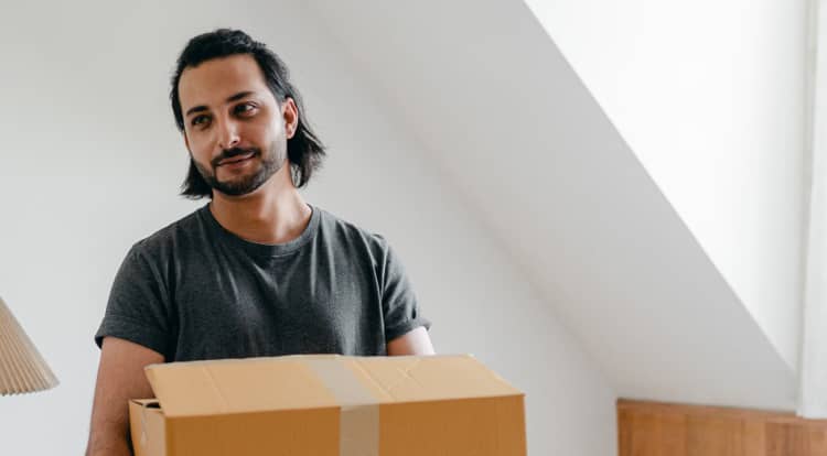 A man carrying a cardboard box