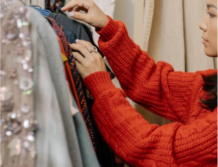 Woman looking through clothing on a rack